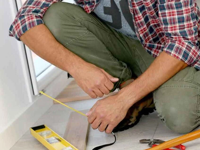 person installing floors in a home